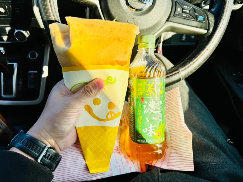 車の中で撮ったビーパス年輪のクレープとペットボトルを並べて大きさを比較した写真です